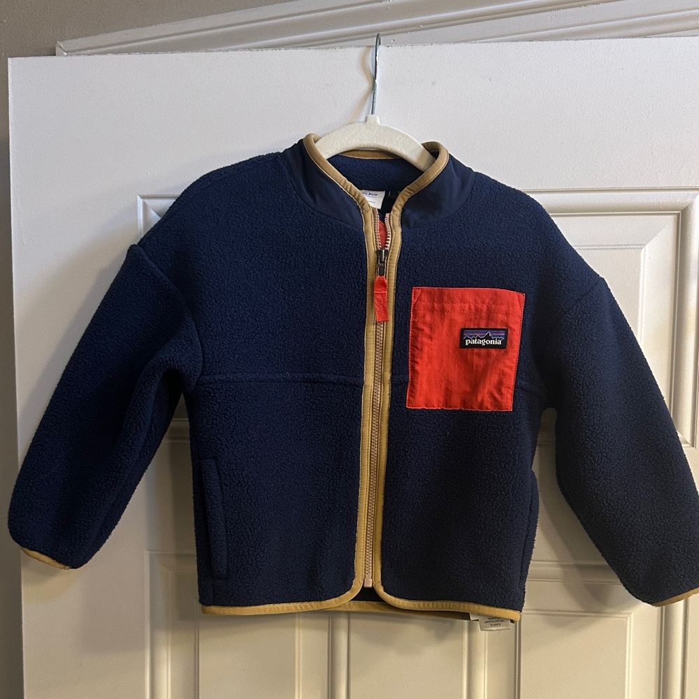 Patagonia Kids Navy Fleece Jacket with Red Chest Pocket and Tan Trim